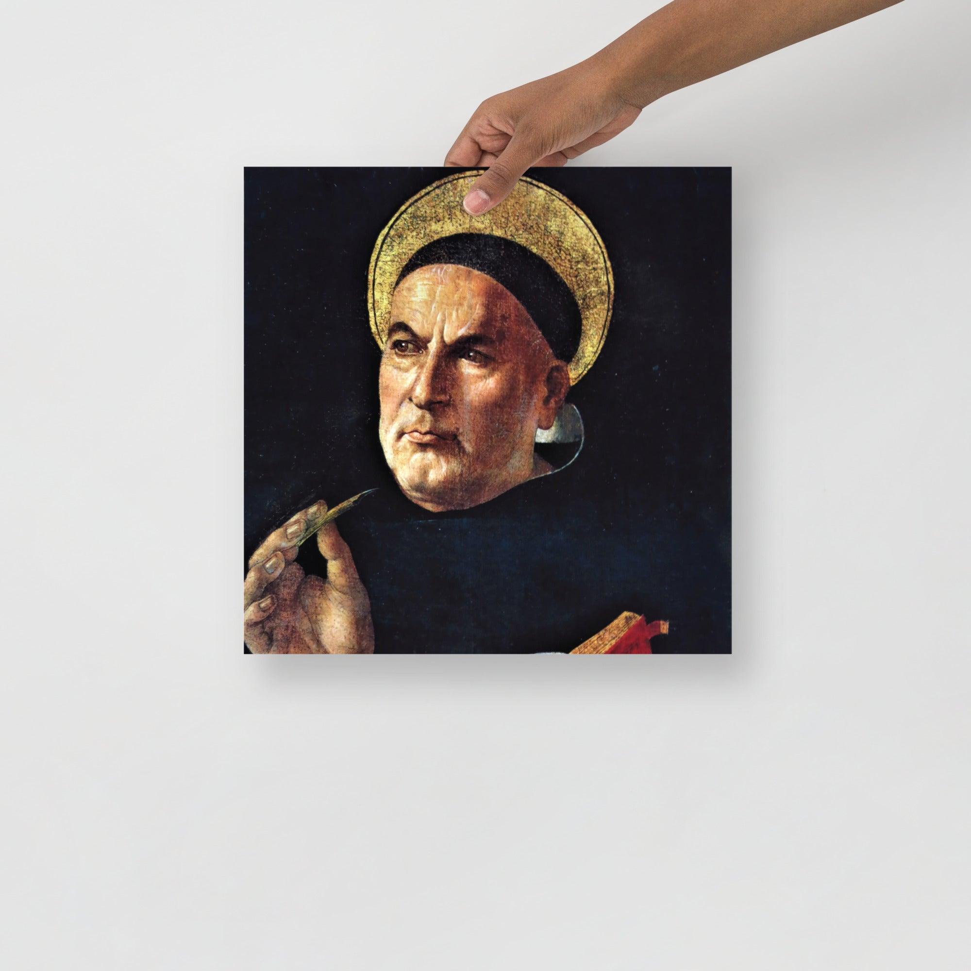 A St. Thomas Aquinas by Sandro Botticelli poster on a plain backdrop in size 14x14”.