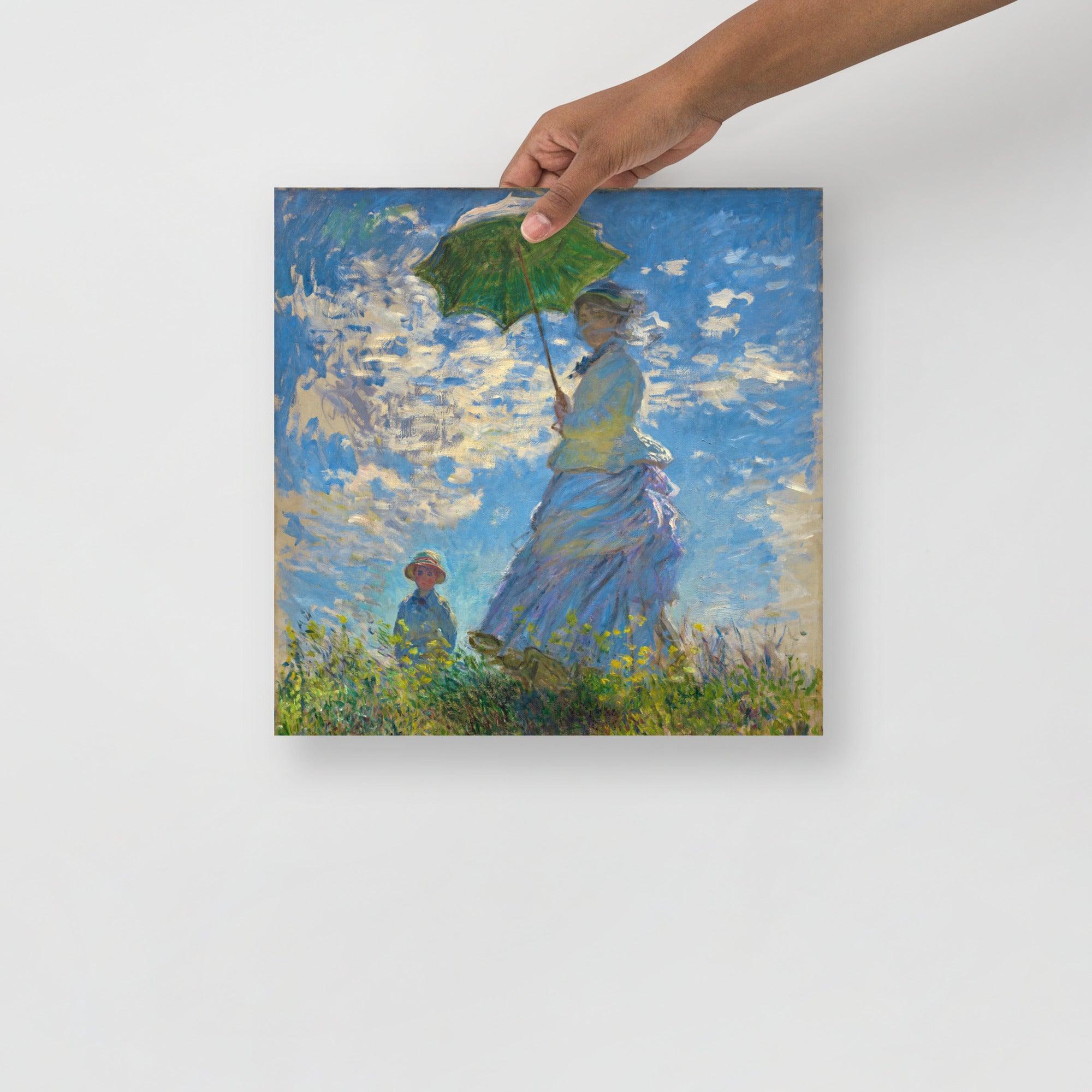 A Madame Monet and Her Son by Claude Monet poster on a plain backdrop in size 14x14”.