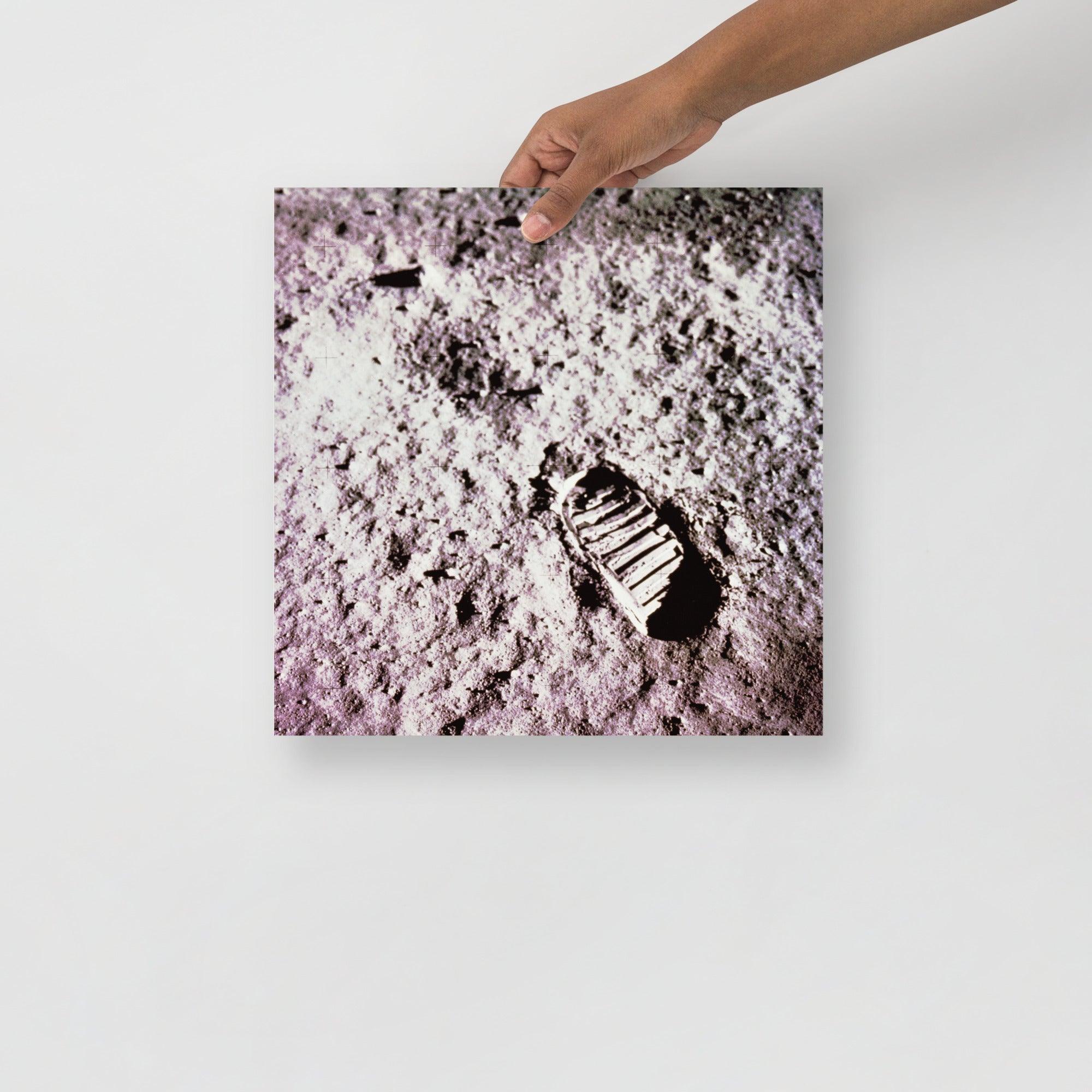 A Footprint on the Moon Apollo 11 poster on a plain backdrop in size 14x14”.