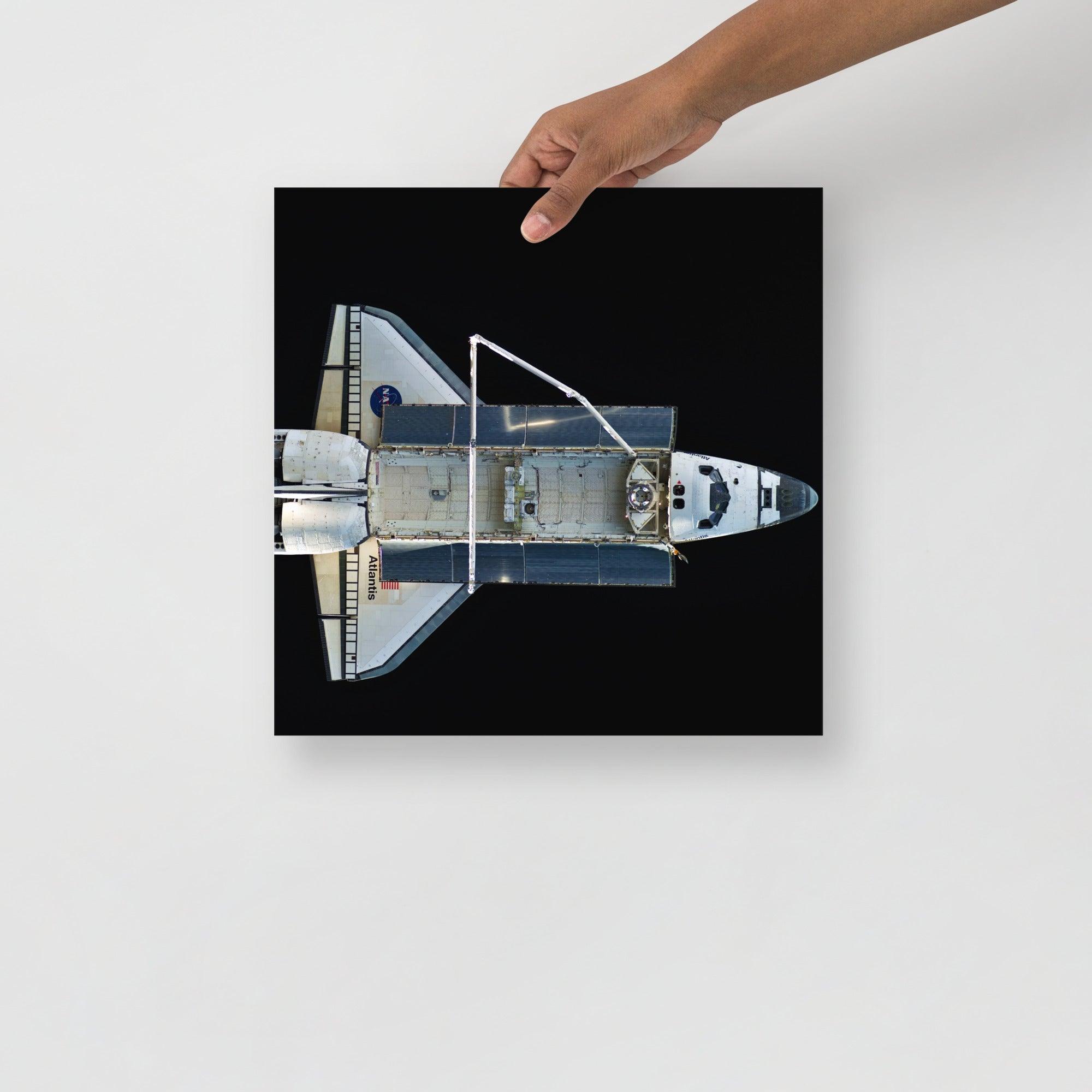 A Space Shuttle Atlantis poster on a plain backdrop in size 14x14”.
