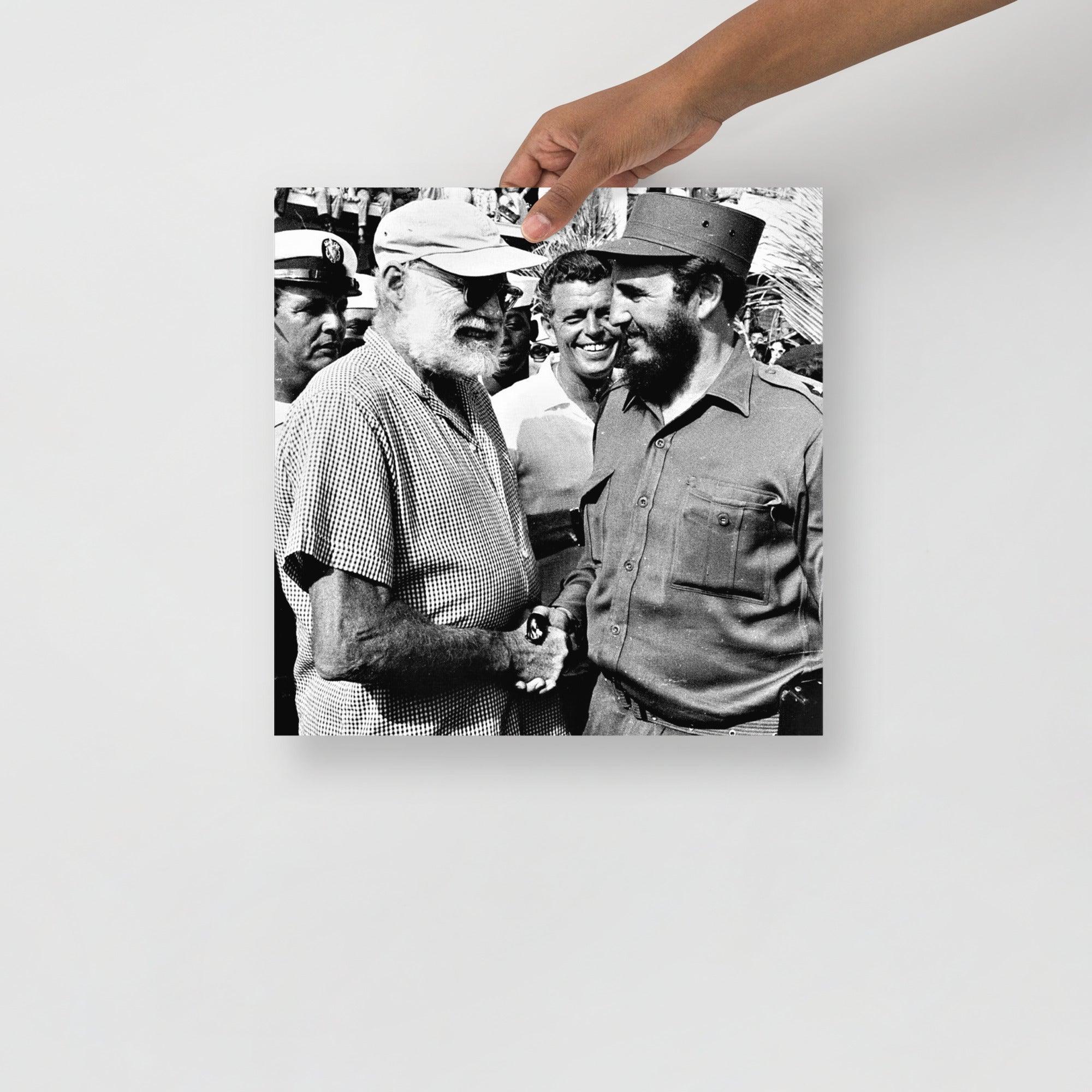 An Ernest Hemingway with Fidel Castro poster on a plain backdrop in size 14x14”.