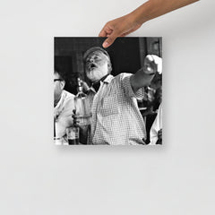 An Ernest Hemingway at a Bar poster on a plain backdrop in size 14x14”.