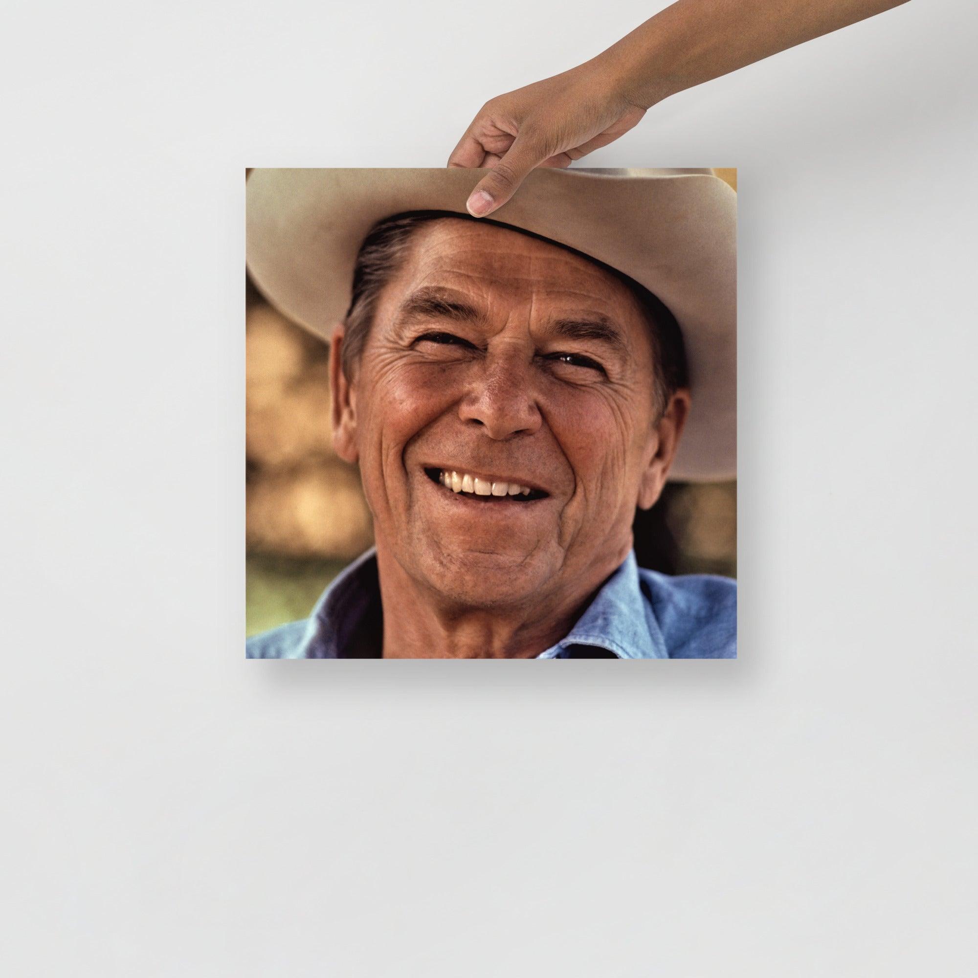 A Ronald Reagan Cowboy Hat poster on a plain backdrop in size 14x14”.