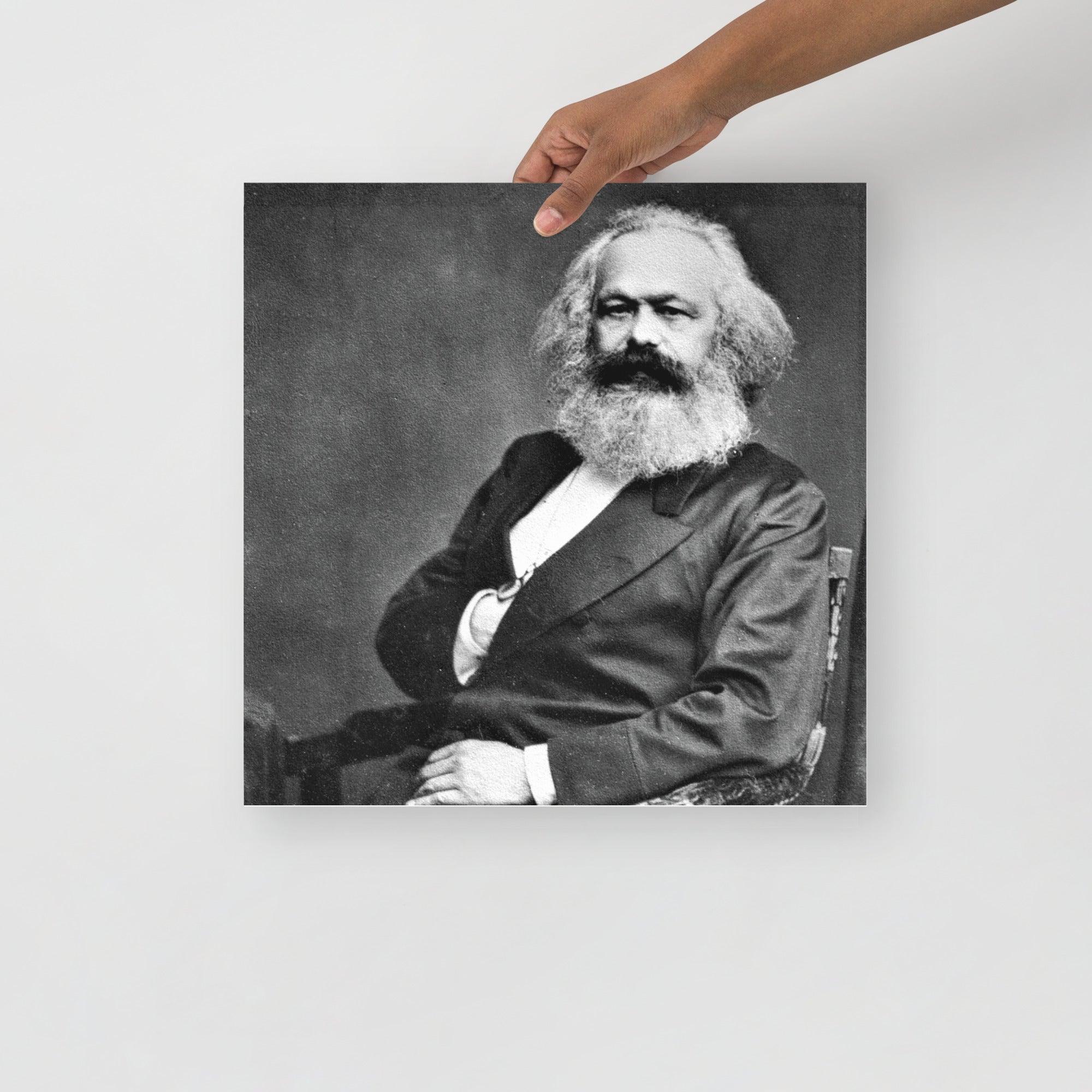 A Karl Marx poster on a plain backdrop in size 16x16”.