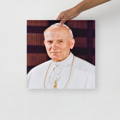 A Pope John Paul II poster on a plain backdrop in size 16x16”.