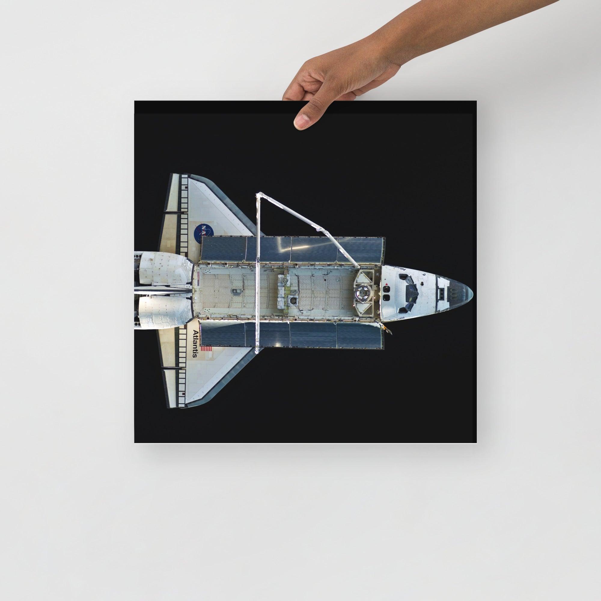 A Space Shuttle Atlantis poster on a plain backdrop in size 16x16”.