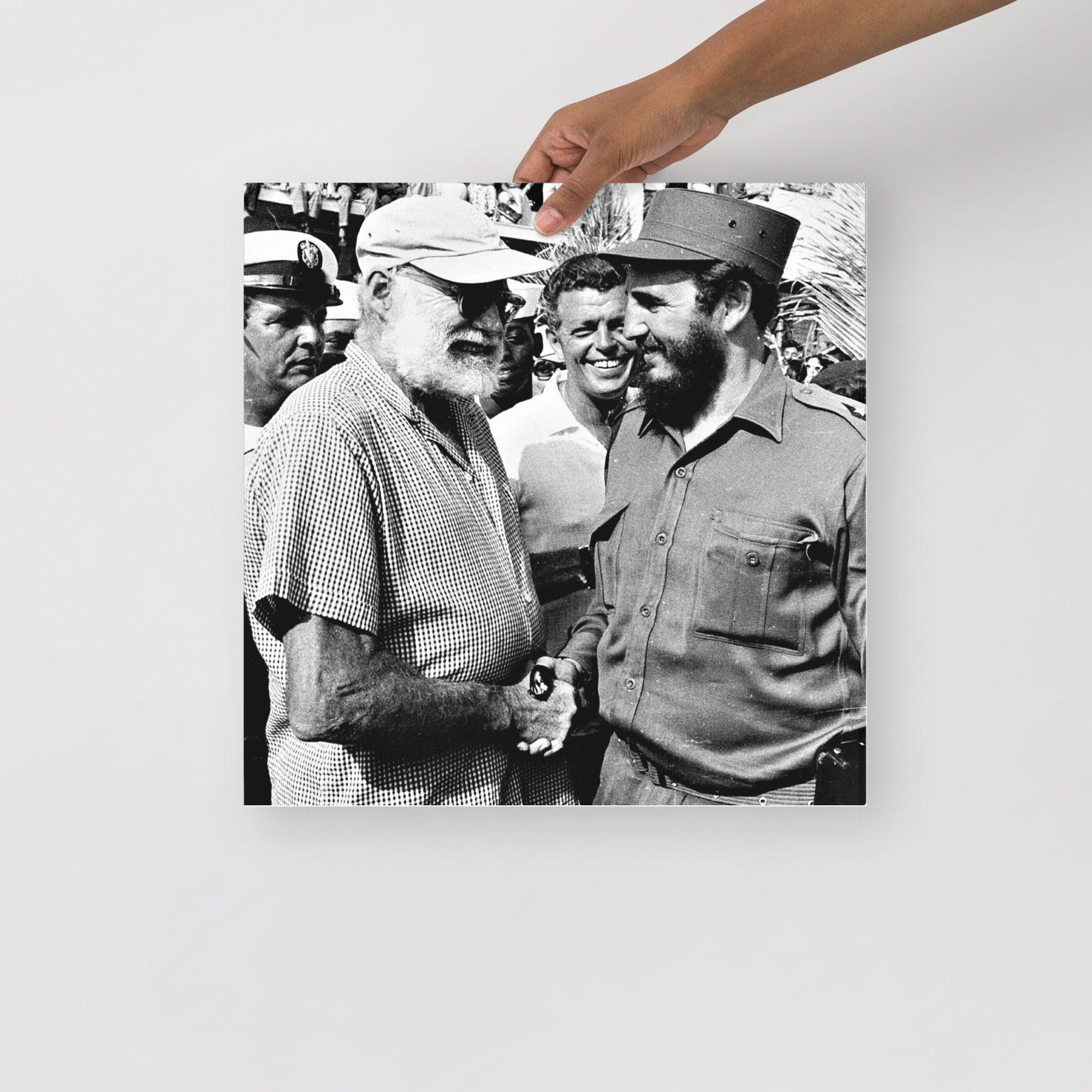 An Ernest Hemingway with Fidel Castro poster on a plain backdrop in size 16x16”.