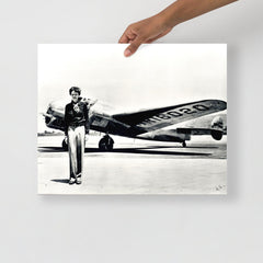 An Amelia Earhart standing in front of the Lockheed Electra on a plain backdrop in size 16x20”.