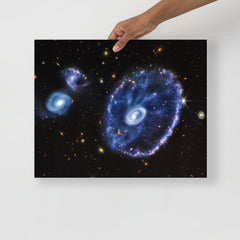 A Cartwheel Galaxy by James Webb Space Telescope poster on a plain backdrop in size 16x20”.