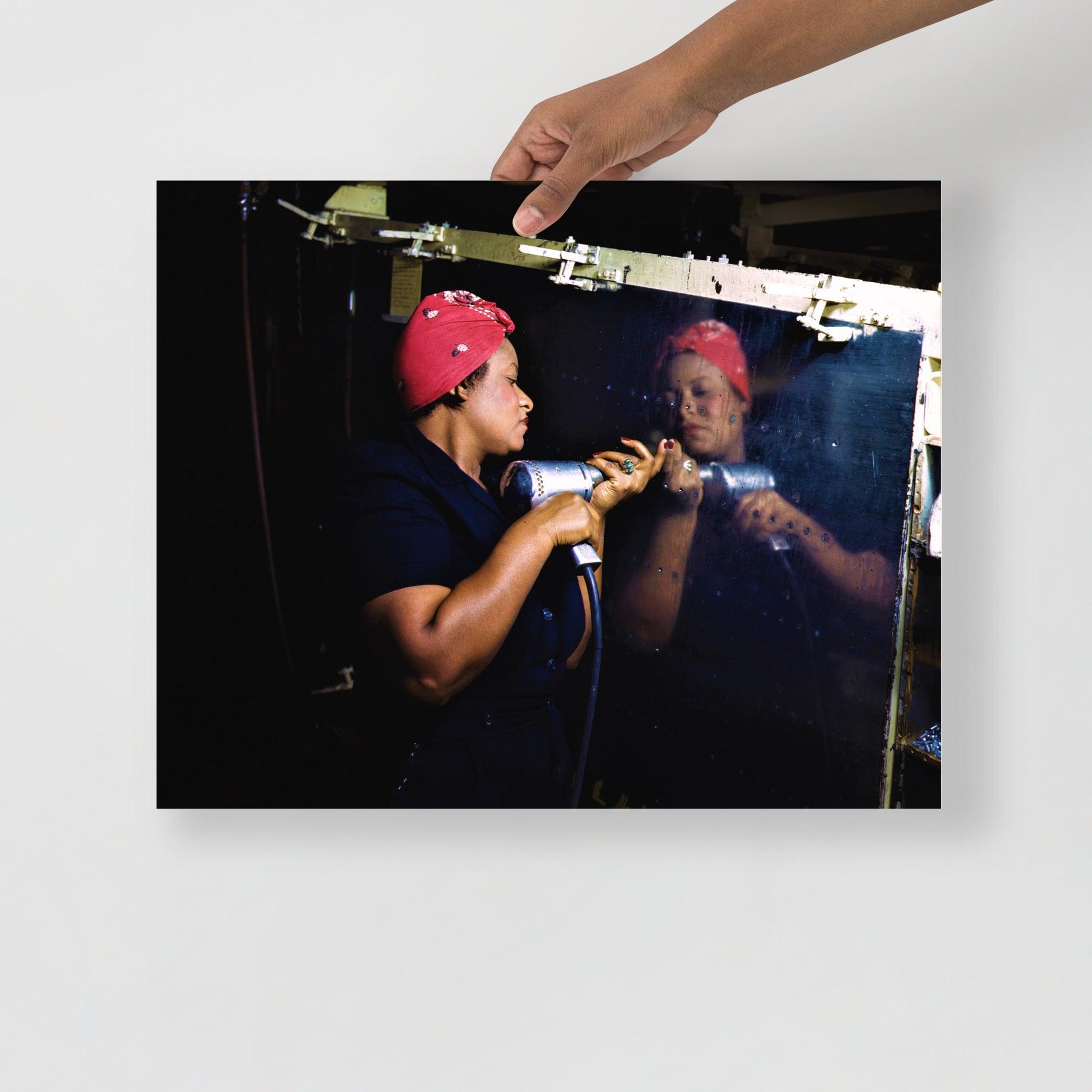 A Rosie the Riveter poster on a plain backdrop in size 16x20”.