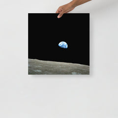 An Earthrise Apollo 8 poster on a plain backdrop in size 18x18”.