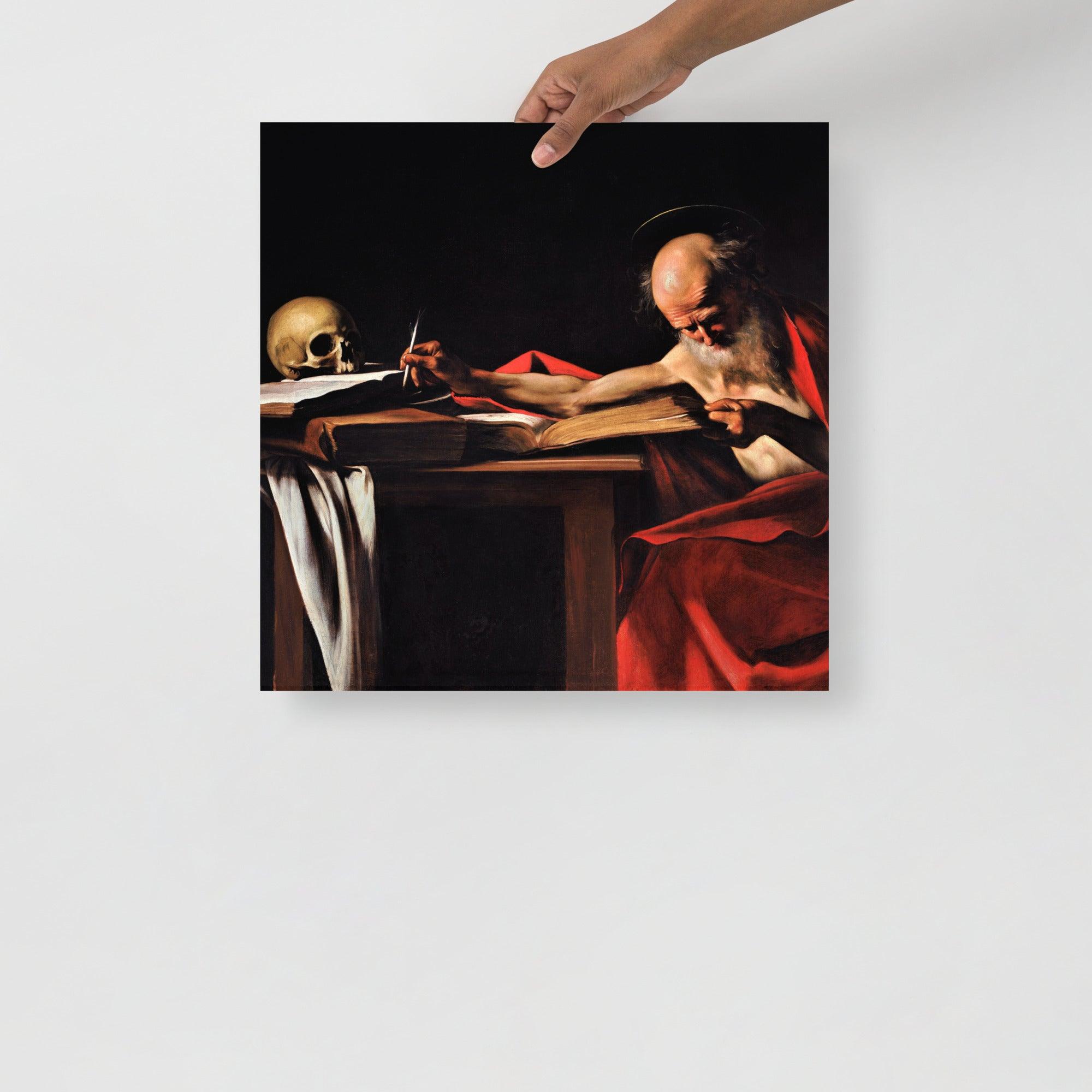 A Saint Jerome Writing by Caravaggio poster on a plain backdrop in size 18x18”.