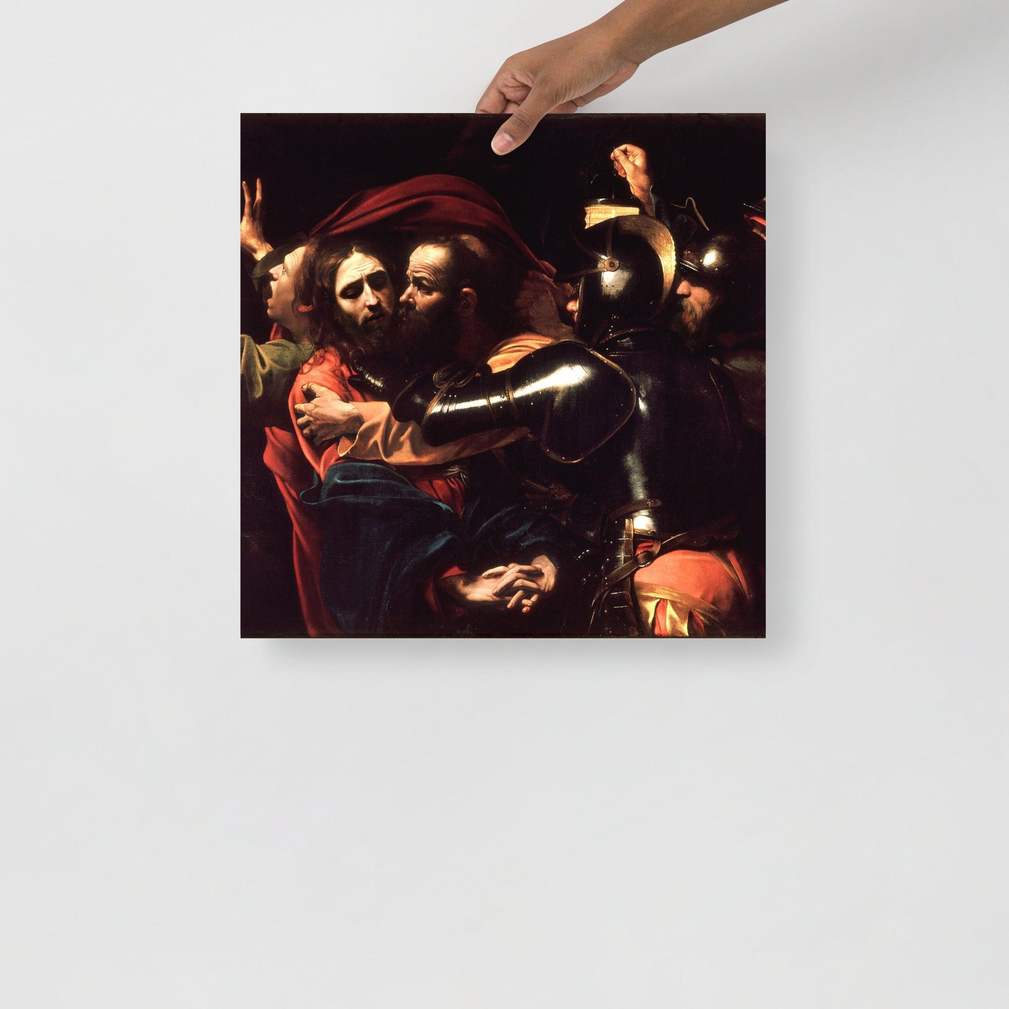 The Taking of Christ by Caravaggio poster on a plain backdrop in size 18x18”.