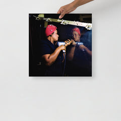 A Rosie the Riveter poster on a plain backdrop in size 18x18”.