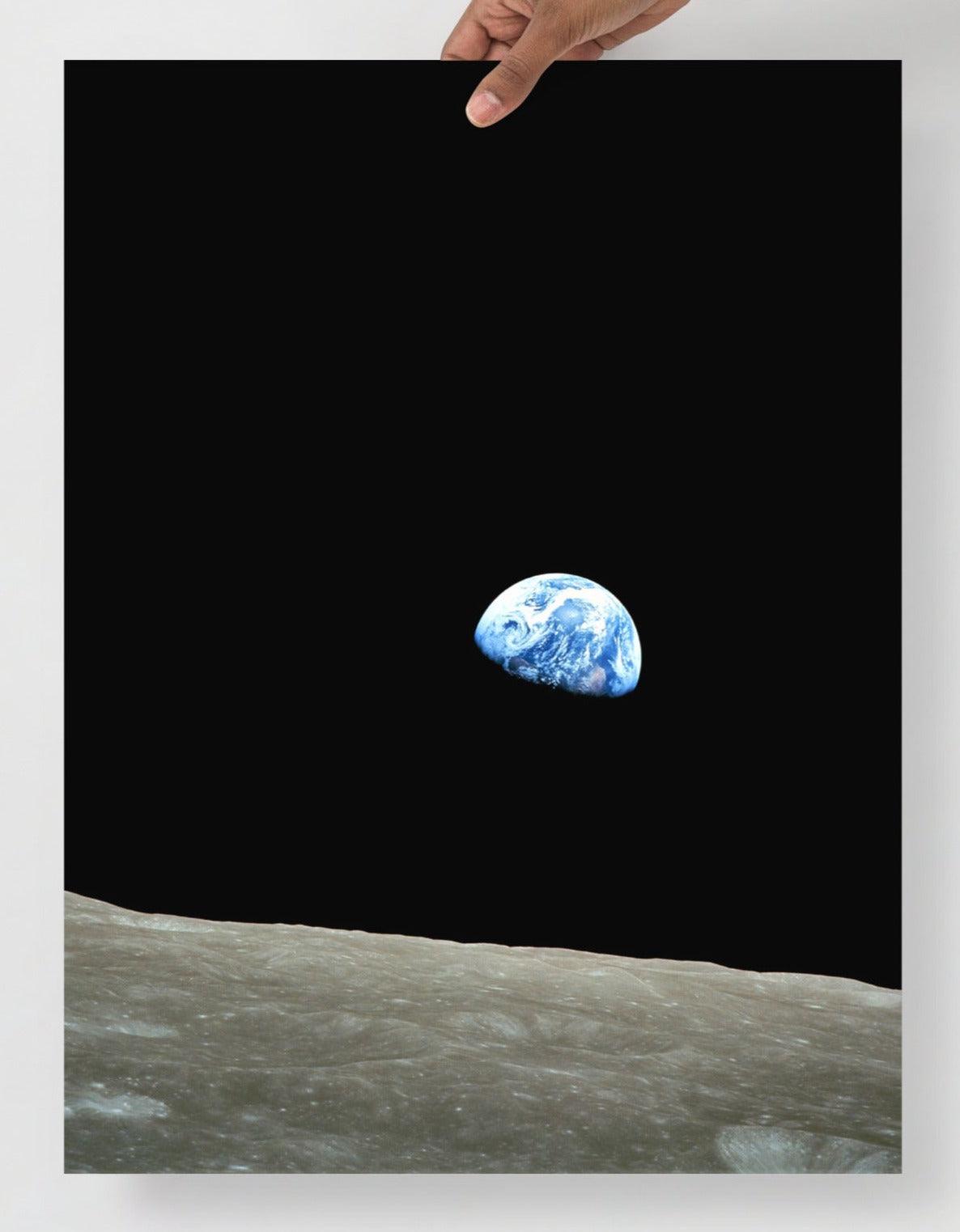 An Earthrise Apollo 8 poster on a plain backdrop in size 18x24”.