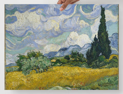 A Wheat Field with Cypresses by Vincent van Gogh poster on a plain backdrop in size 18x24”.