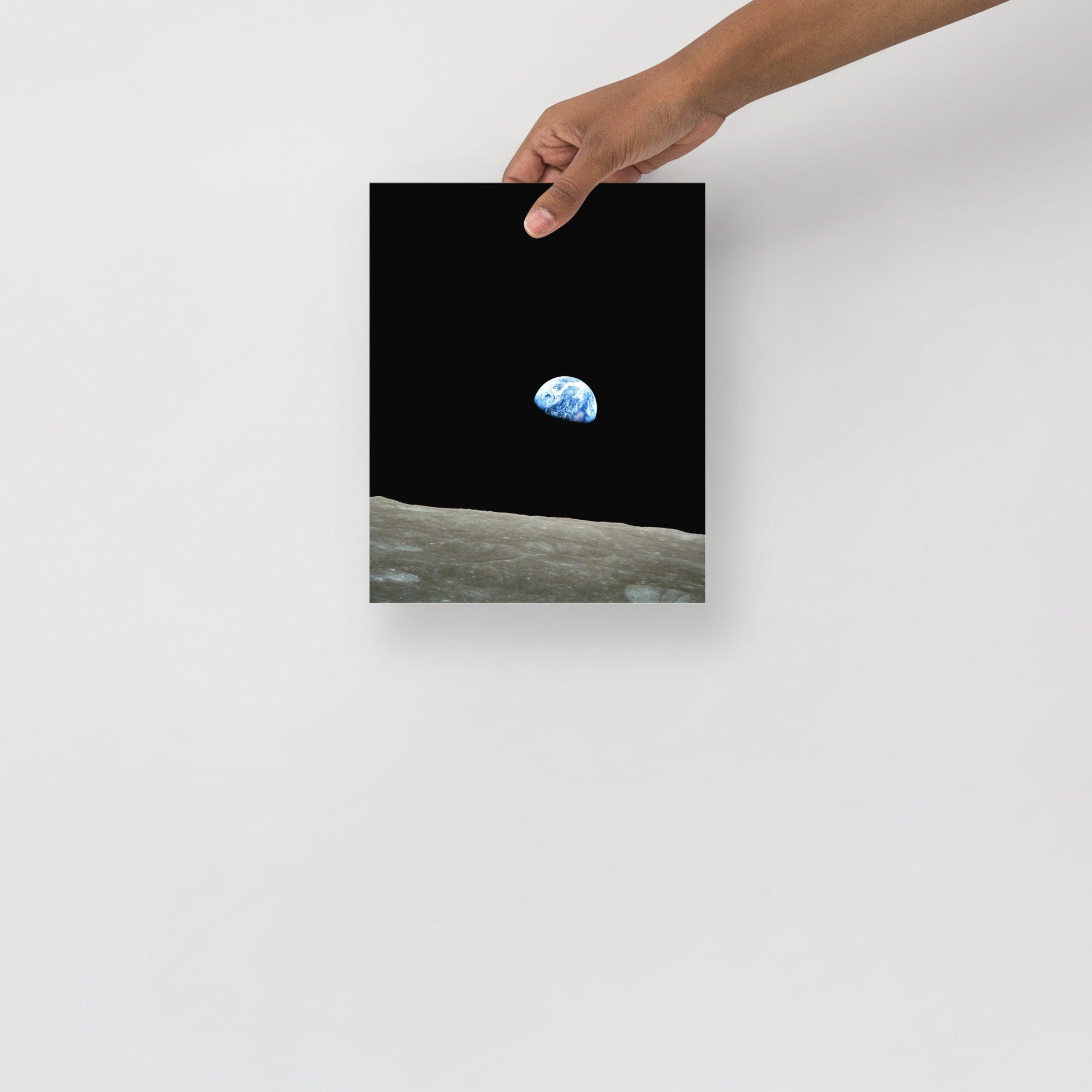 An Earthrise Apollo 8 poster on a plain backdrop in size 8x10”.