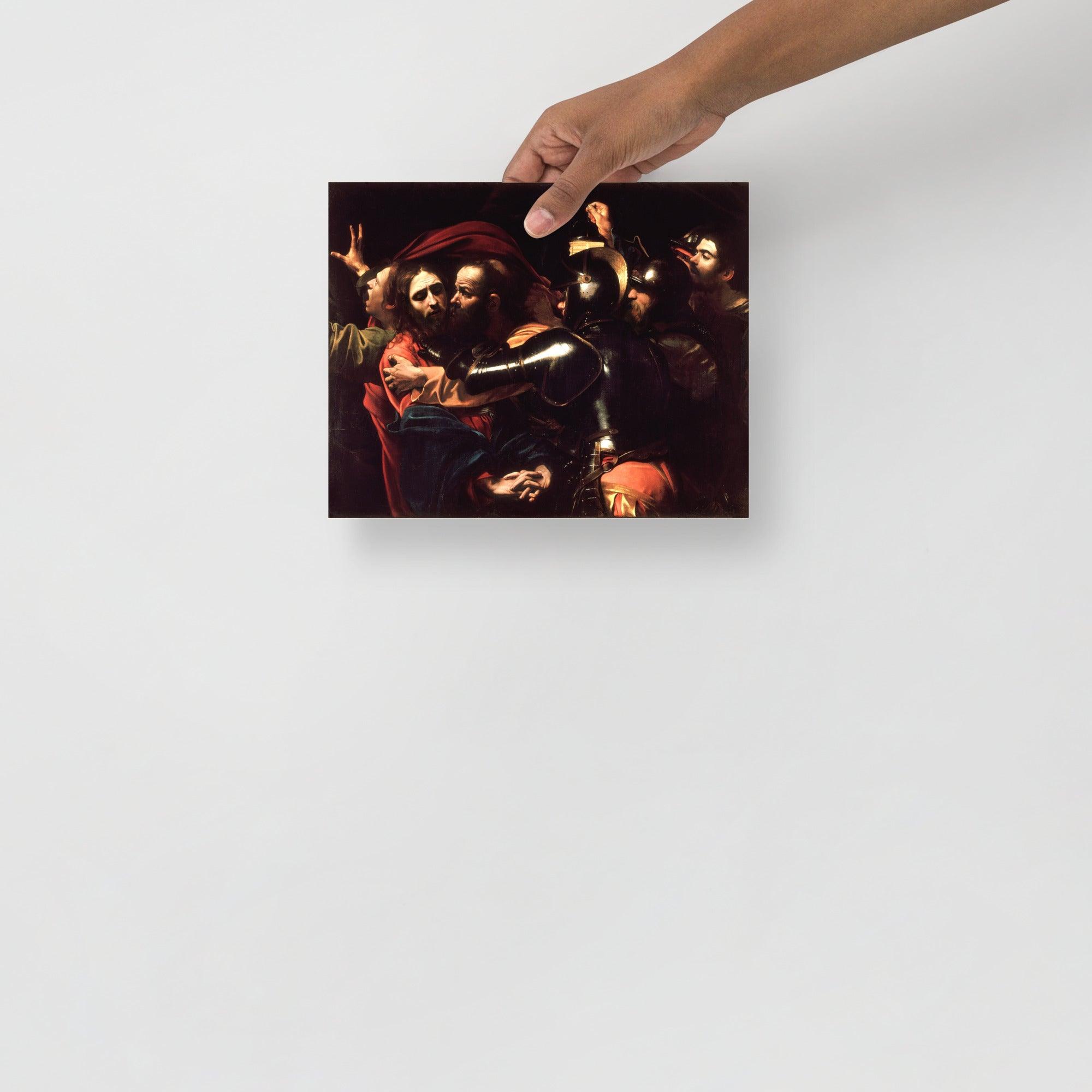 The Taking of Christ by Caravaggio poster on a plain backdrop in size 8x10”.