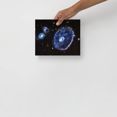 A Cartwheel Galaxy by James Webb Space Telescope poster on a plain backdrop in size 8x10”.